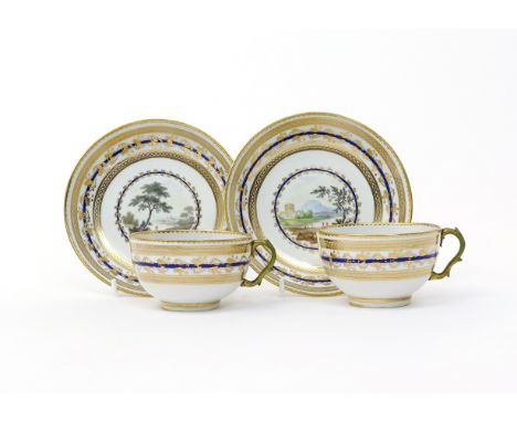 A pair of Derby teacups and saucers  c.1790, painted in pattern number 86 with central landscape panels by Zachariah Boreman,