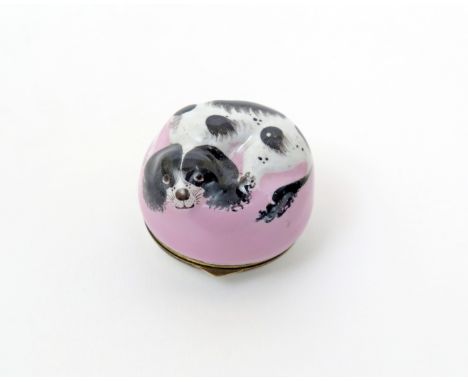 A Bilston enamel bonbonnière   c.1770, modelled as a black and white spaniel curled up on a pink cushion, the metal-mounted a