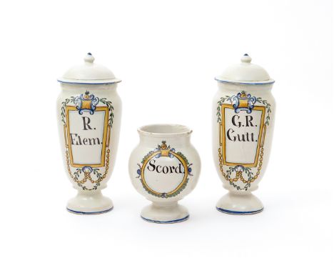 A garniture of three Spanish faïence drug jars and covers  c.1800, each painted with a cartouche in yellow, ochre, blue, gree