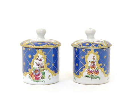 A small pair of enamel pommade or toilet pots and covers  c.1800, the cylindrical forms painted with flower sprays beneath a 