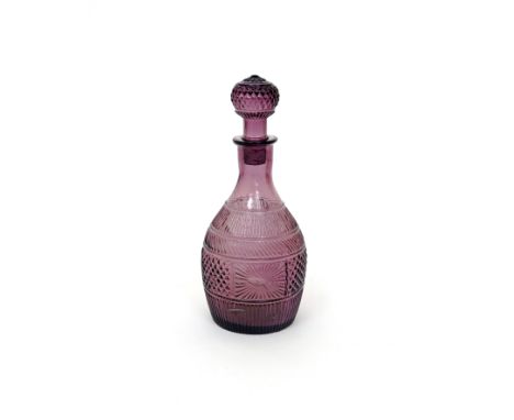 An amethyst glass decanter and stopper  c.1820, perhaps American, moulded with starburst designs and diamond banding, 27cm. (