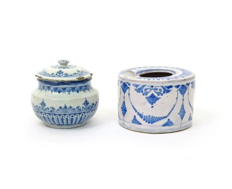 A Delft jar and cover  18th century, the squat body painted in blue with a lambrequin border above a band of lappets, the cov