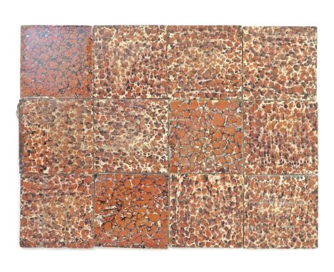 Twelve slipware tiles  c.1750-70, probably Bristol, decorated with a marbled design in rusty orange and manganese on a cream 