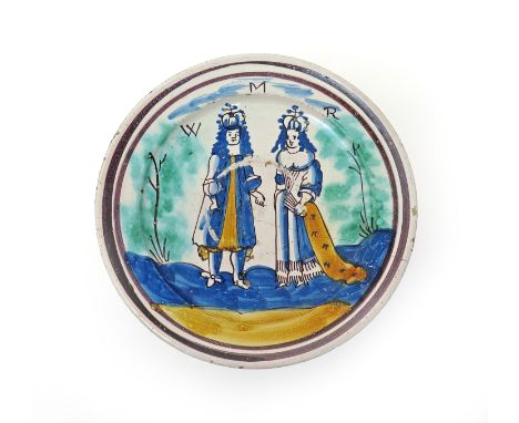 A London delftware Royal charger  c.1690, painted in polychrome enamels with a full length portrait of William and Mary benea