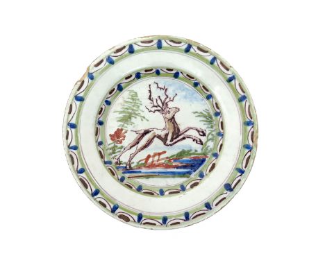 A delftware plate  1st half 18th century, perhaps London, decorated in blue, green, red and manganese with a leaping stag to 