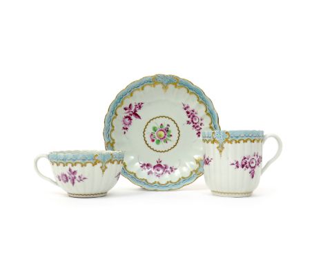 A Worcester trio  c.1775-80, comprising a teacup, coffee cup and saucer, the fluted forms painted with three puce flower spra