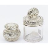 A large Victorian plain glass silver mounted toilet bottle and cover, the collar and cover profusely