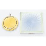 A George V silver mounted yellow guilloche enamel powder case, mirror interior, on suspension