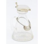 An Edwardian silver mounted glass whiskey / brandy noggin, the silver hallmarked by Goldsmiths &