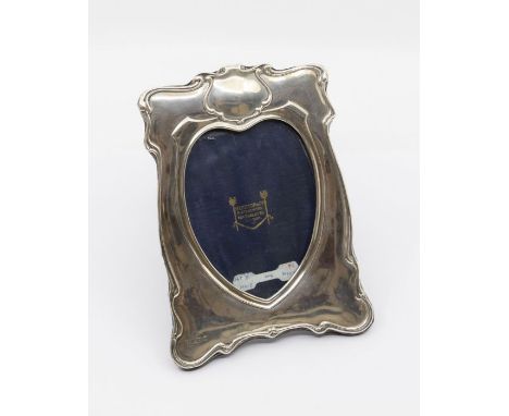 An Art Nouveau style silver mirror, shaped border with heart shaped inset, easel velvet backed, hallmarked by Henry Matthews,