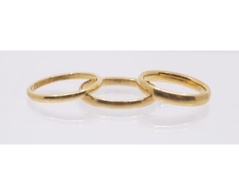 Three 22ct gold bands, various widths, sizes K, N, Q1/2, combined weight approx 9.6gms&nbsp;