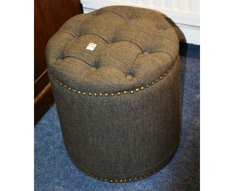 A modern fabric covered circular pouffe stool, 46cm high