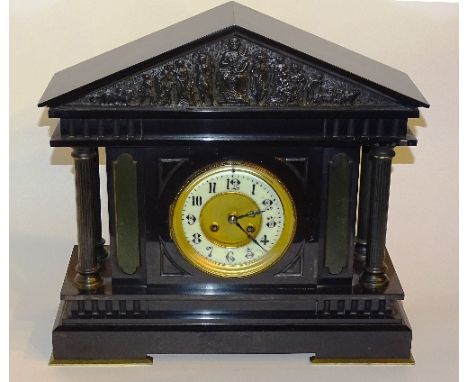 A Victorian black slate mantel clock, the white enamel chapter ring dial with Arabic numerals, the arched pediment decorated 