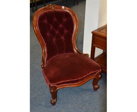 A Victorian mahogany gossip chair, with button back and serpentine shaped seat, upholstered in wine velour, 83cm high