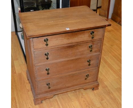 A vintage chest of drawers, of small form, with four graduated drawers, raised on bracket supports, 76cm high x 69.5cm wide x