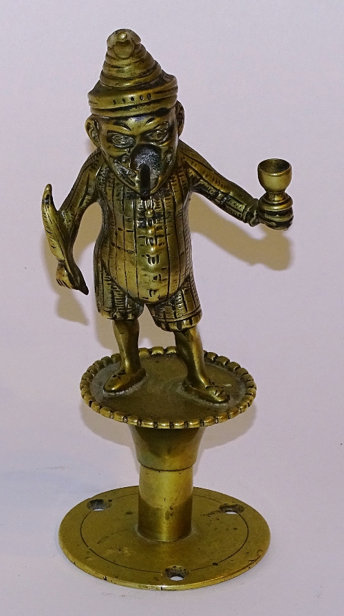 **A Victorian brass 'Mr Punch' bar lighter, with hole through cigar in