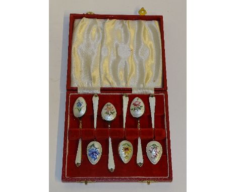 A cased set of six silver gilt and enamel coffee spoons, hallmarks for Birmingham 1959 Adie Brothers, the cream enamel with f