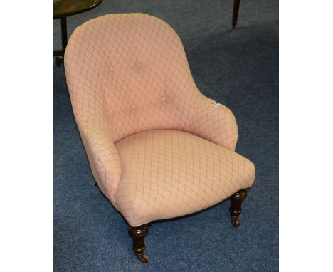 A late Victorian gossip chair, upholstered in later pink button back fabric, 69cm high