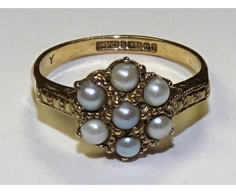 A 9ct gold pearl flowerhead ring, stamped 375 to underside, ring size O, 2.5g