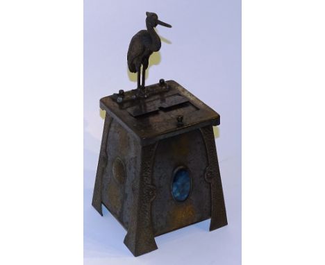 **An Arts & Crafts hammered metal novelty cigarette dispenser circa early 20th century, modelled as an automaton crane, actio