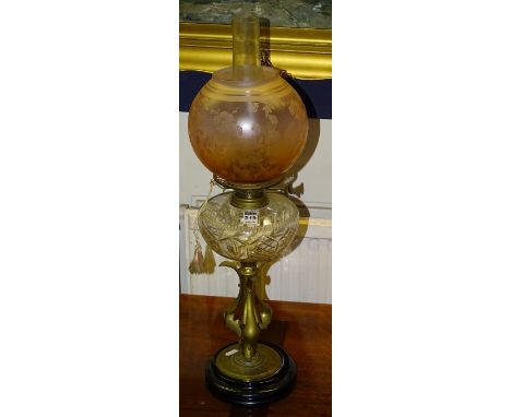 A vintage brass oil lamp circa early 20th century, with glass reservoir and later glass shade and funnel, 67cm high