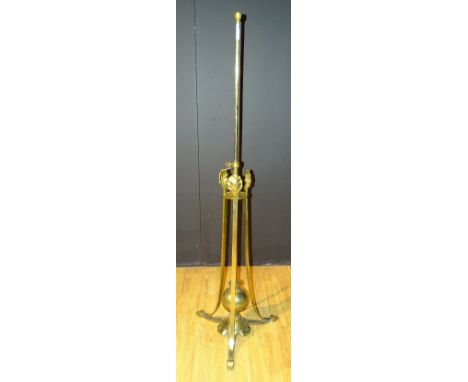 **An Art Nouveau brass telescopic floor lamp, with stylized leaf supports, terminating on tripod platform base with heart sha