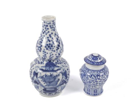 Two small Chinese vases. A 19th century Chinese small blue and white bottle vase of double gourd form with apocryphal four ch