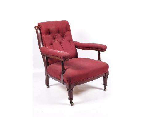 A Maples Howard style open armchair. With mahogany frame and turned supports, upholstered with patterned red fabric and butto