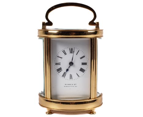 Wynne &amp; Co, Gloucester Road, an oval brass cased carriage clock, in a leather case.