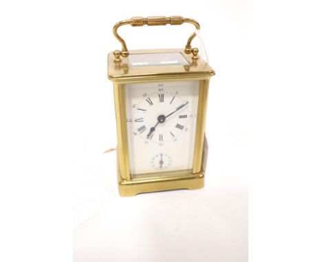 A circa 1900 cased carriage alarm clock. Striking on a bell with two dials to front, bevelled glass panels, 14 cm high (handl