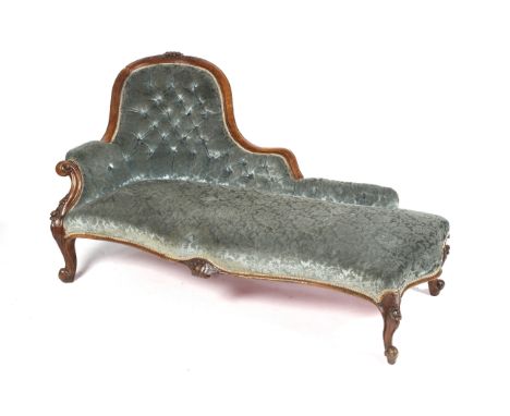 A  Victorian walnut serpentine chaise lounge. With show wood surround, carved decoration, button back duck egg blue upholster