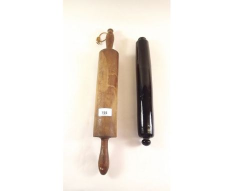 An old wooden rolling pin and a Victorian green glass one 