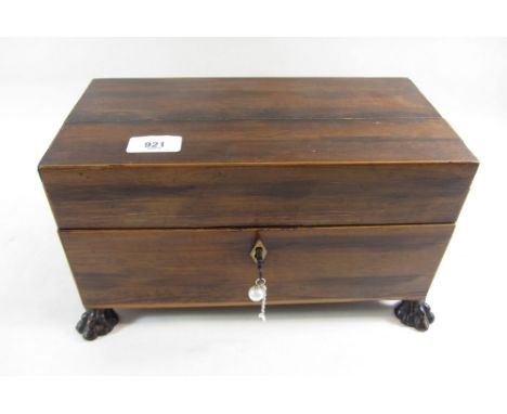 A 19th century rosewood and satinwood tea caddy on paw feet with interior caddies 