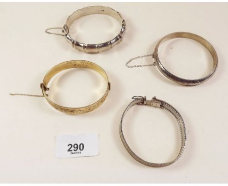 Three silver bangles and a rolled gold bangle