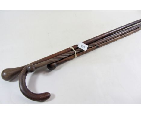 Three walking canes and a walking stick 