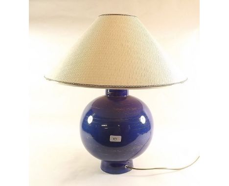 A large blue spherical table lamp and shade