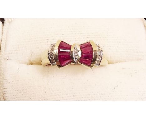 A 9 carat gold ruby and diamond bow design ring