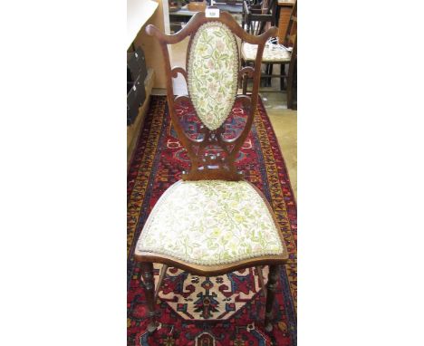 A Victorian side chair with interlaced shield form back and tapestry seat all on turned spindle supports