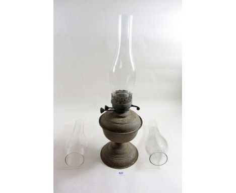 An old brass oil lamp and three glass chimneys 