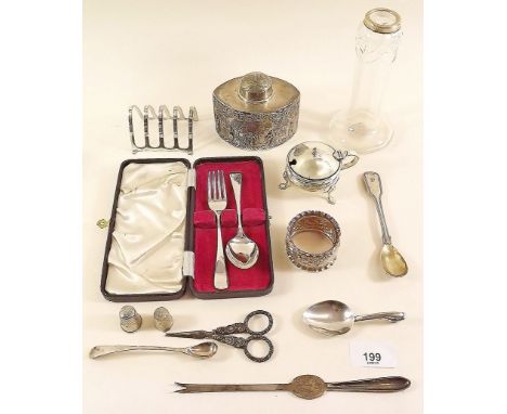 A box of silver items including toast rack, mustard pot, child's cutlery set and silver plated tea caddy etc 