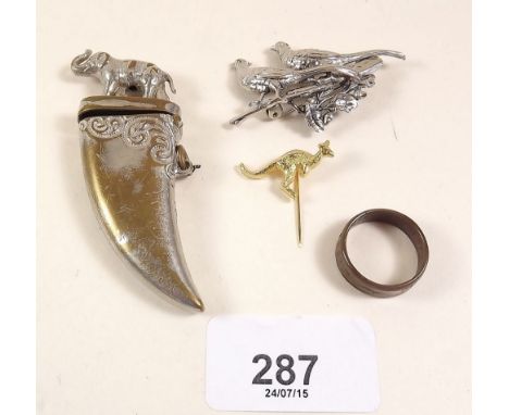 A novelty tiger claw form silver plated vesta, a pheasant brooch, a half penny ring and a kangaroo stick pin 