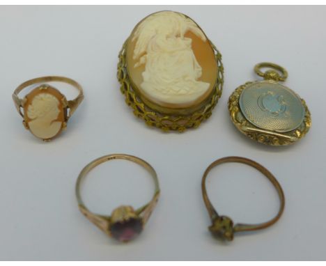 A yellow metal cameo ring, a cameo brooch, a locket, a rolled gold ring, and a 9ct gold and red stone ring, 1.3g, K