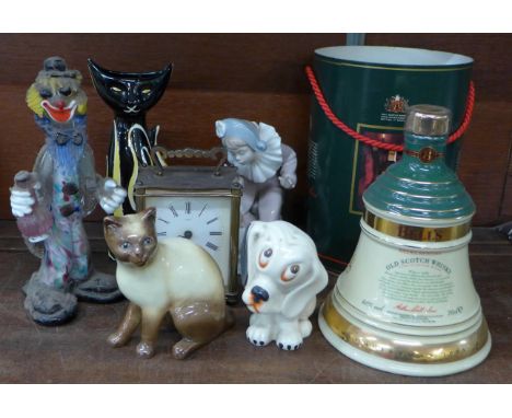 A Crown Devon Bonzo dog figure, a Sylvac cat, a Nao figure, Murano glass clown, a Bell's Whisky decanter, sealed, a Smith's c