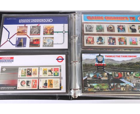 An album of Royal Mail mint stamp presentation packs including Comedy Greats, Smilers 2015, Roald Dahl, Star Wars, Christmas 