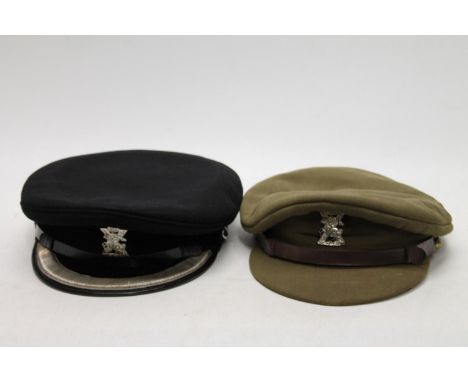 Two Fife Light Horse peaked caps, both with white metal Thane of Fife badges, the khaki green example with label to interior 