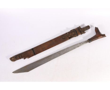 Borneo Dyak mandau or parang ilang headhunters sword with craved wood grip and scabbard, blade length 51cm, sword length 66cm