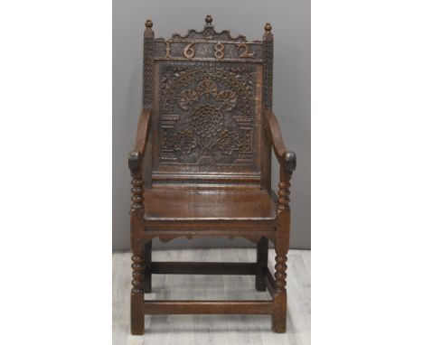 17thC English jointed oak wainscot chair with shaped pediment dated 1682, turned finials and Tudor rose style motif, the sing