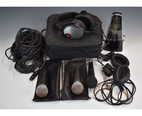 Three microphones comprising two Shure SM58 and Peavey with clips and leads, a set of cased headphones, harmonica brace and a