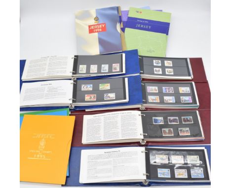 A large mint stamps collection of Jersey, Guernsey and Isle of Man in presentation packs, year packs, four Davo albums and in