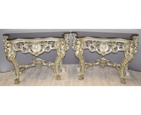 Pair of royalcore style silver coloured shaped console table with mask decoration and black marble tops, W138 x D51 x H88cm